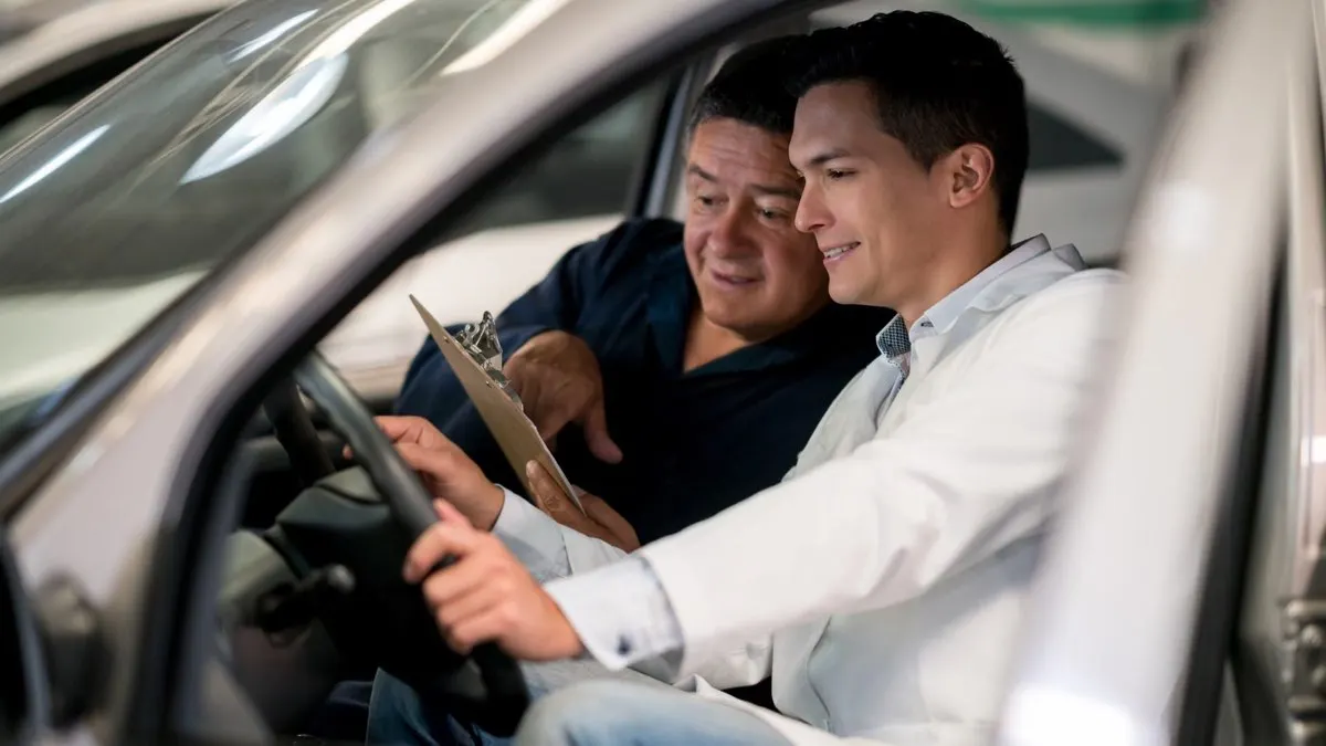 Technician reviewing a service checklist with a driver at an interlock appointment
