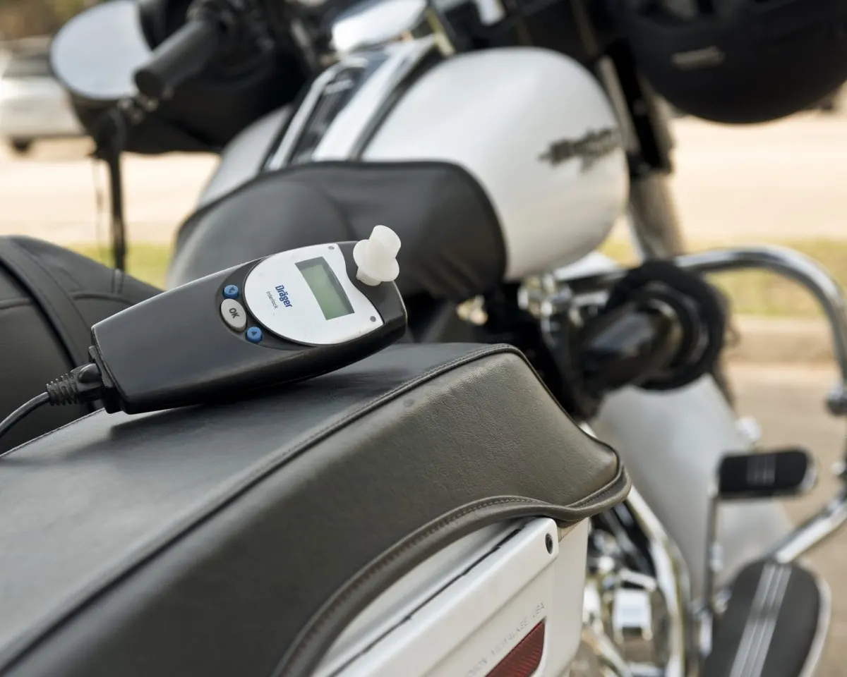 Dräger interlock handset resting on the seat of a touring motorcycle.